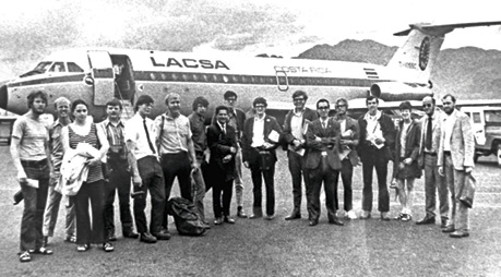 A group of people standing in front of a helicopter

Description automatically generated with medium confidence
